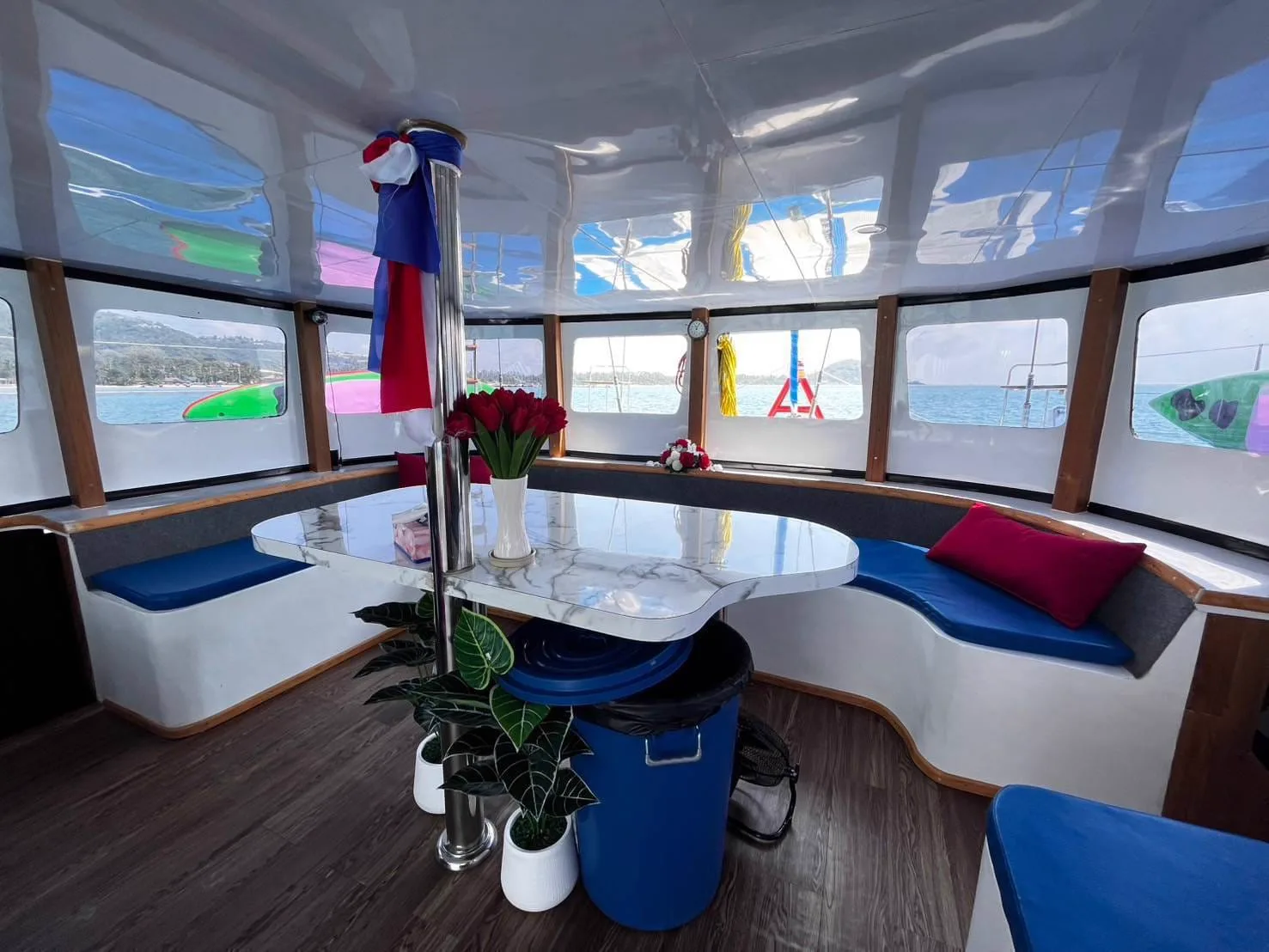 Cushioned lounge deck with dining table on board a private boat