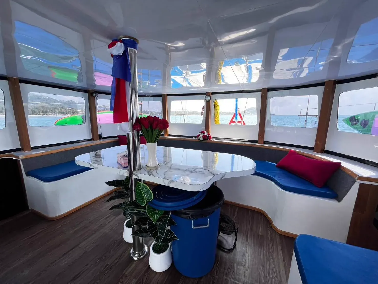 Cushioned lounge deck with dining table on board a private boat