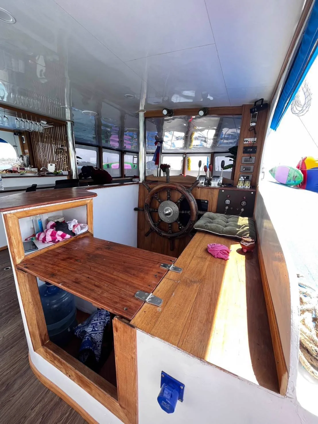 Wooden ship's wheel and helm station on the private boat