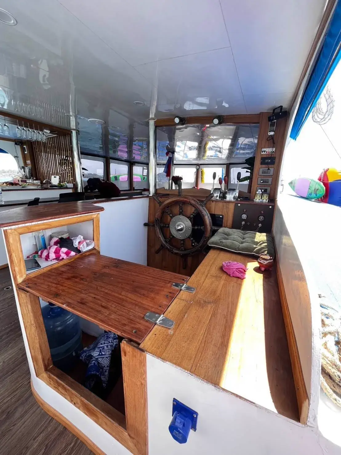 Wooden ship's wheel and helm station on the private boat