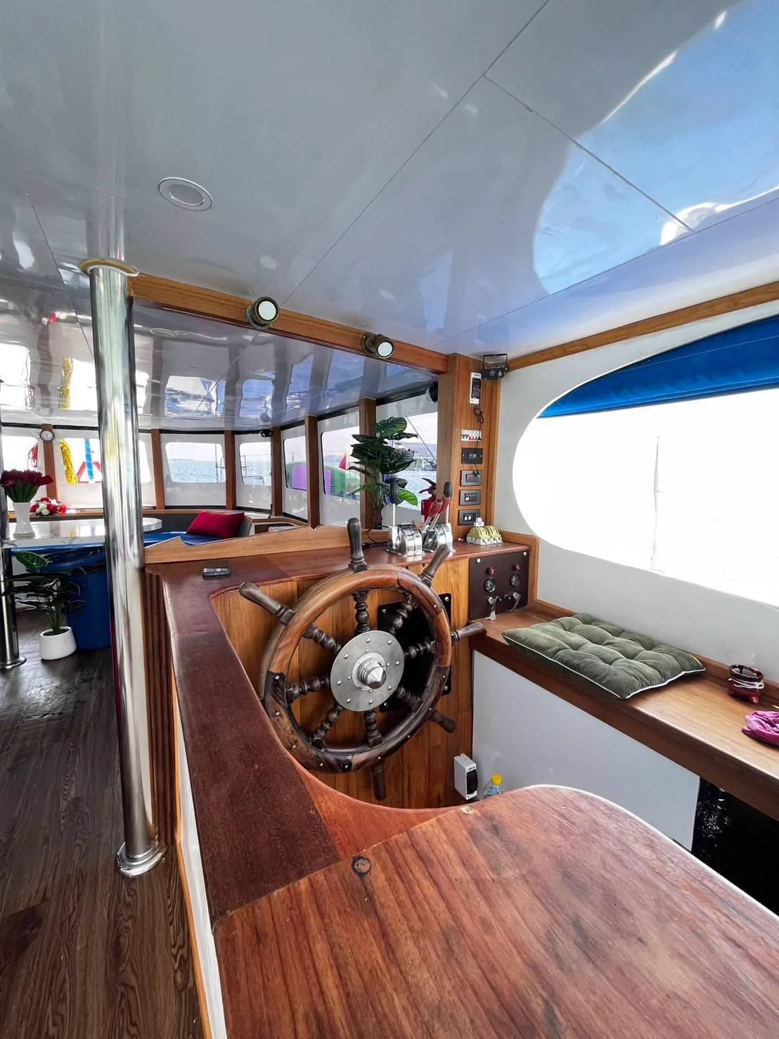 Captain's cockpit and steering wheel on board the private boat