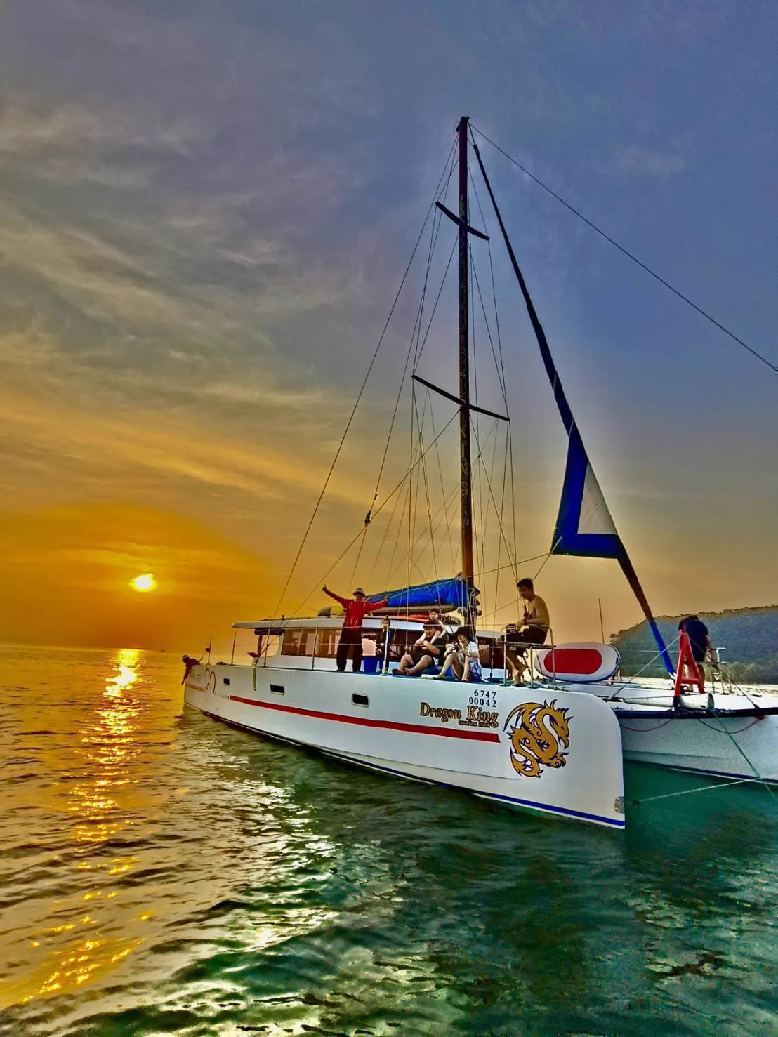 Guests enjoying a sunset sail on a private catamaran charter from Koh Samui